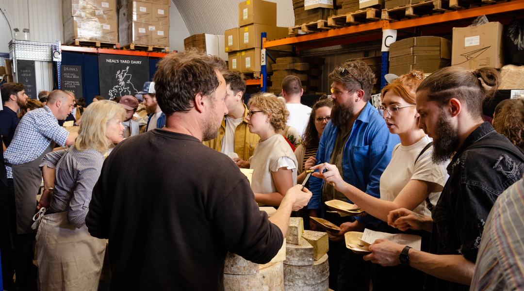 Cheesemakers sample out cheese to crowds at our Wholesale Open Day